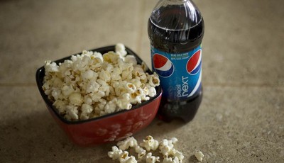 
              In this Monday, Oct. 15, 2012, photo,  a bottle of  Pepsi is displayed next to popcorn in Pembroke Pines, Fla.  PepsiCo Inc.